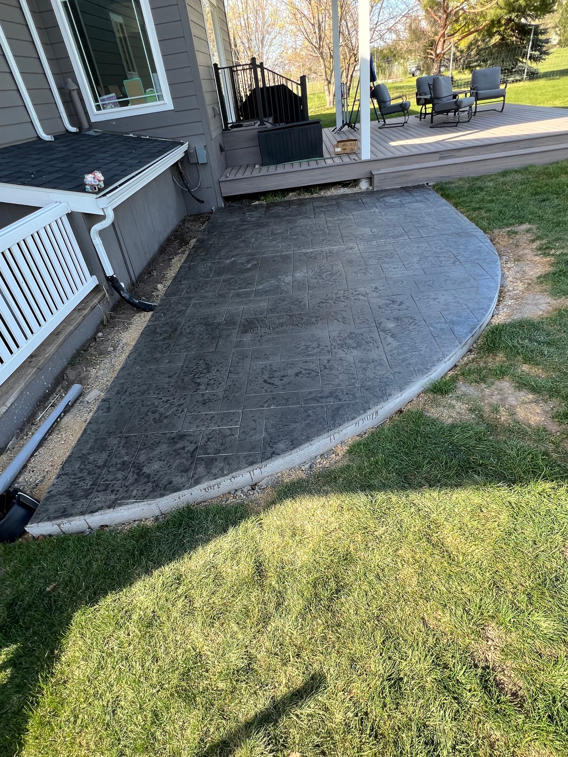 Gallery photos for Stamped Concrete Hot Tub Pad Turns Bare Backyard Into Usable Space: Image #1